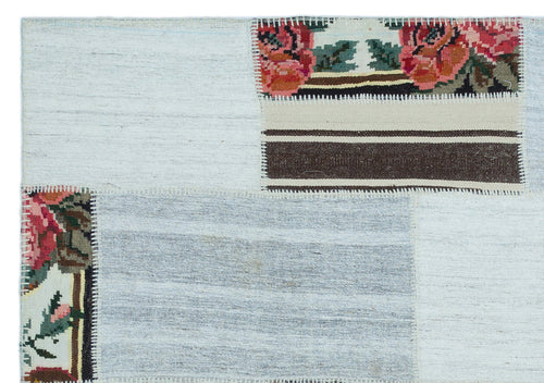 Teselya Red Floral Wool Handmade Area Rug 5'0" x 7'1"