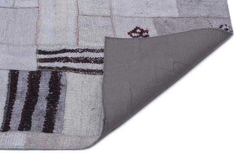 Teselya Purple Patchwork Wool Handmade Area Rug 5'3" x 7'7"